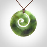 This picture shows a hand carved New Zealand jade koru pendant