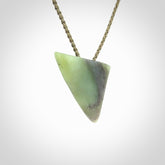 This is a lovely New Zealand Jade, pounamu niho drop pendant. It is bound with an adjustable khaki coloured cord which is length adjustable.