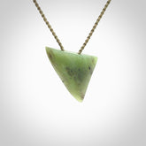 This is a lovely New Zealand Jade, pounamu niho drop pendant. It is bound with an adjustable khaki coloured cord which is length adjustable.