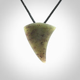 This is a lovely New Zealand Jade, pounamu niho drop pendant. It is bound with an adjustable black coloured cord which is length adjustable.