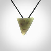 This is a lovely New Zealand Jade, pounamu niho drop pendant. It is bound with an adjustable black coloured cord which is length adjustable.