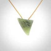 This is a lovely New Zealand Jade, pounamu niho drop pendant. It is bound with an adjustable beige coloured cord which is length adjustable.