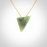 This is a lovely New Zealand Jade, pounamu niho drop pendant. It is bound with an adjustable beige coloured cord which is length adjustable.