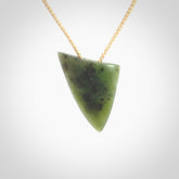 This is a lovely New Zealand Jade, pounamu niho drop pendant. It is bound with an adjustable beige coloured cord which is length adjustable.