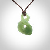 Hand carved small New Zealand Inanga jade twist pendant.