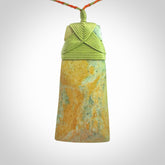 Hand carved Toki pendant from a lovely piece of local New Zealand Flower Jade. We have suspended this from a orange and green cord which can be adjusted with a couple of slip knots and green binding.