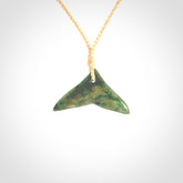 Hand carved New Zealand Marsden Jade whale tail pendant.