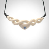 A hand carved twist pendant made from bone. This is a work of art carved by Fumio Noguchi who is renowned for his skill in bone carving. We deliver this pendant to you on a plaited black cord. Delivery with Express Courier is included in the price.