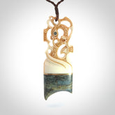 This is a large carved Manaia pendant. It is made from unique materials - New Zealand Obay Stone, Bone, Paua shell, Brass. The face of the Manaia is carved with a traditional design in the front. It is carved front and back and has traditional carved designs. This is a large and very traditional pendant that is a collectors piece.