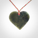 A hand carved heart pendant made from New Zealand jade.
