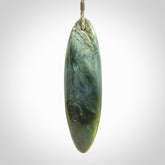 This picture shows a beautiful large sized drop pendant carved in New Zealand Tangiwai pounamu. It is a lovely chatoyant green/blue colour, which is semi-translucent when held to the light. A gorgeous and very meaningful pendant with an adjustable cord.