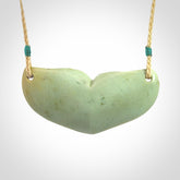 Hand carved New Zealand Flower Jade whale tail pendant.