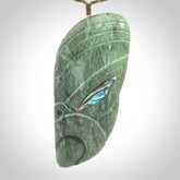 This is a hand carved New Zealand Jade wheku pendant. It is made from New Zealand Jade and Paua shell.
