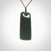 This is a lovely New Zealand Jade, pounamu drop pendant. Hand carved for us by Kyohei Noguchi. It is bound with an adjustable brown coloured cord which is length adjustable. Free worldwide shipping.