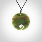 This koru, is carved from a very striking New Zealand Totoweka jade. Pounamu koru pendant hand made by Ric Moor. One only Koru necklace provided with a black adjustable cord.