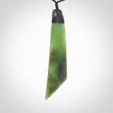 Hand carved large Toki pendant from a lovely piece of local New Zealand Jade. The quality of the workmanship and design is outstanding - this is a piece you will want to wear all the time. We have suspended this from a 4-plait black cord which can be adjusted with a couple of slip knots and black binding.