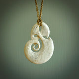 A hand carved path of life design pendant from Whale Bone. The cord tan and is adjustable. Large hand made Koru necklaces by New Zealand artist Kerry Thompson.