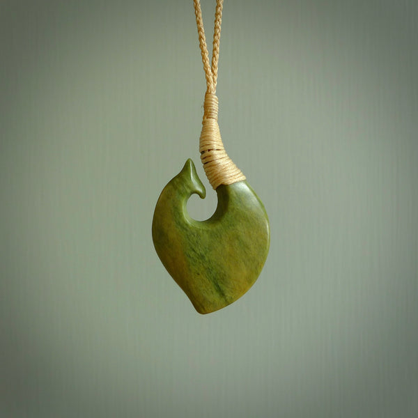 This matau, is carved from a very striking New Zealand jade. It is both intricate and simple in design - it has hidden folds and smooth curves. A piece to be worn or displayed - the carving and the jade are both magnificent. Hand made by Donna Summers.