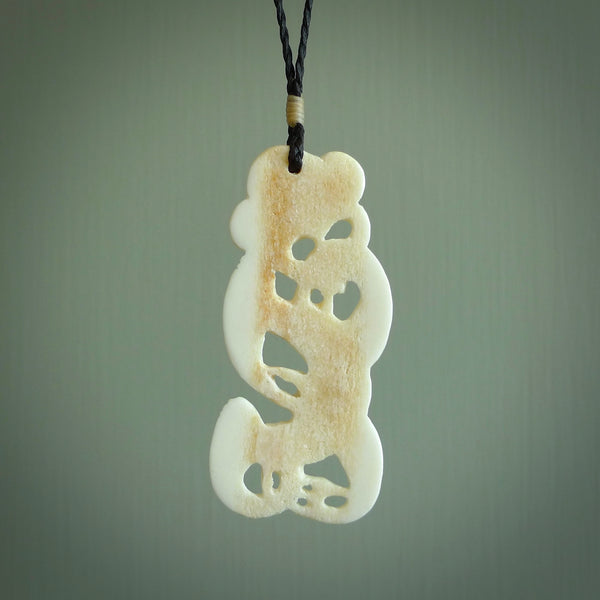 Hand carved bone Tiki pendant. Traditional art hand carved for NZ Pacific. Bone Tiki necklace with Paua Shell eyes.