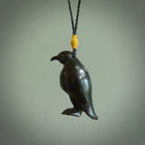 This pendant is a hand carved YELLOW EYED penguin. We've carved this from a lovely piece of black jade and we provide it with a hand plaited cord. Shipping is free worldwide.