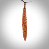 Bone carving of a lizard climbing. A three dimensional pendant carved in bone by Yuri Terenyi.