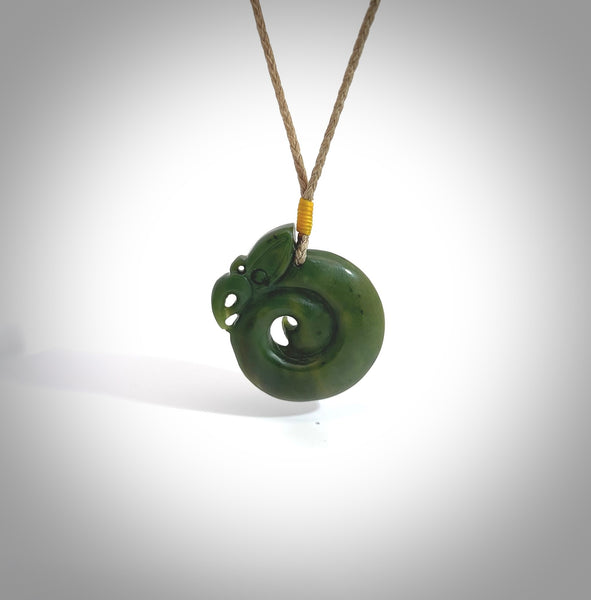 Hand carved medium sized jade manaia with koru pendant. Made for NZ Pacific by Ross Crump. We will ship this to you with an express courier service. This is a one-off piece and is collectable. A gorgeous pendant!