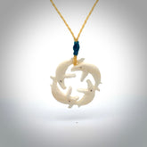 Hand carved natural bone four whale pendant. Art to wear. Ocean themed pendants.