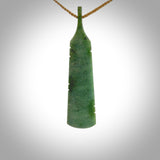 A hand carved large New Zealand Jade feather necklace. The cord is a tan colour and is a fixed length. A large sized hand made Jade feather necklace by New Zealand artist Kerry Thompson. One off work of art to wear.