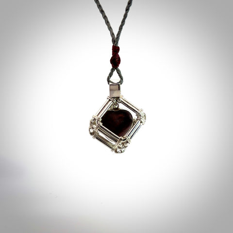 Red Jasper stone heart carving in Sterling Silver surround box. Hand carved for NZ Pacific. Handmade jewellery for sale online. The cord is a 3-braid plait in silver grey and is adjustable. Jasper heart necklace for men and women. Heart necklace hand made from Jasper and sterling silver.