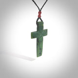 Hand carved Matte New Zealand jade cross necklace. Religious symbol pendant. Christian cross pendant for sale online. Hand crafted from New Zealand Jade Pounamu, free worldwide delivery.