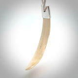 Hand carved, engraved Boars Tusk Pendant with a sterling silver cap. Hand made pendant carved from a boars tusk. Hand made unique jewellery for sale by NZ Pacific online.