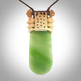 Traditional Polynesian art carved in whale bone with New Zealand Kahurangi Pounamu (Jade). The materials are a blend of whale bone and kahurangi Jade. It is provided with a hand-plaited brown cord that is a fixed length. Free shipping worldwide. One only collectable art to wear.
