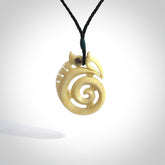 This is a unique manaia with koru, hand carved natural bone pendant with Paua Shell eyes. The cord is Black and is length adjustable. This is delivered to you with Express Courier. The eyes are made from Paua shell.