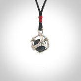 Black Jade round ball carving in Sterling Silver surround box. Hand carved for NZ Pacific. Handmade jewellery for sale online. The cord is a 3-braid plait in black and is adjustable. Black Jade necklace for men and women. Heart necklace hand made from Black Jade and sterling silver.