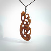 This necklace is carved from cow bone and stained with a homemade tea dye. It is a unique piece of wearable art that is sure to catch the eye. The shape is a complex twist form and has been beautifully hand carved by bone carver Yuri Terenyi.