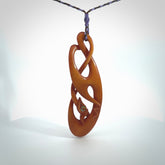 This necklace is carved from cow bone and stained with a homemade tea dye. It is a unique piece of wearable art that is sure to catch the eye. The shape is a complex twist form and has been beautifully hand carved by bone carver Yuri Terenyi.