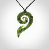 This photo shows a koru pendant carved from New Zealand Jade. The artist, Shaun Gardiner, has carved this beautifully. We provide this piece with an adjustable Black cord. This is a fantastic work of art, we have one only.