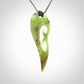 This photo shows a koru pendant carved from New Zealand Jade. The artist, Shaun Gardiner, has carved this beautifully. We provide this piece with an adjustable khaki cord. This is a fantastic work of art, we have one only.