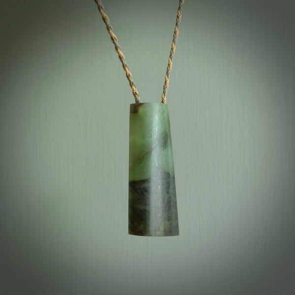 This photo shows a medium sized jade drop shaped pendant. It a a lovely, colourful douglas creek jade. The cord is a tan/green and is adjustable in length. One only large, contemporary drop necklace from Jade, by Rueben Tipene.