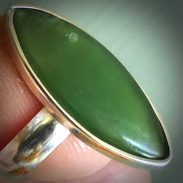 This is a handcrafted New Zealand Pounamu, Jade and sterling silver ring. This is a solid little work of art. We ship this worldwide for free and are happy to answer any questions that you may have about these or other products on our website. Delivered with Express Courier and packaged in a woven kete pouch.
