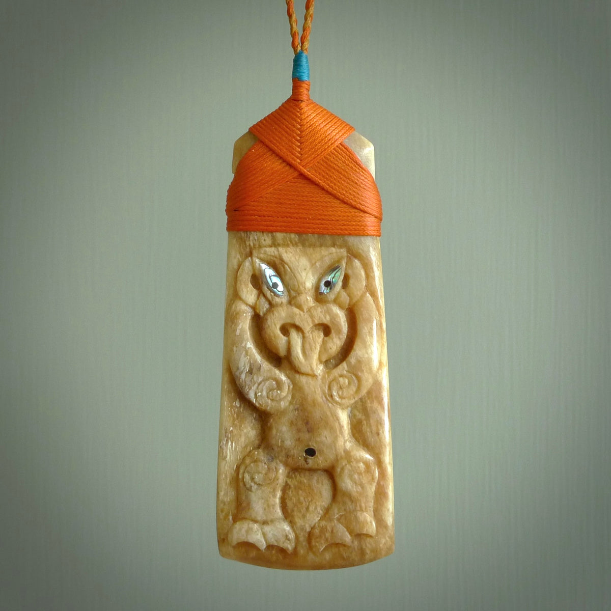 HAND CARVED BONE TOKI WITH TIKI PENDANT. BONE TOKI WITH TIKI PENDANT