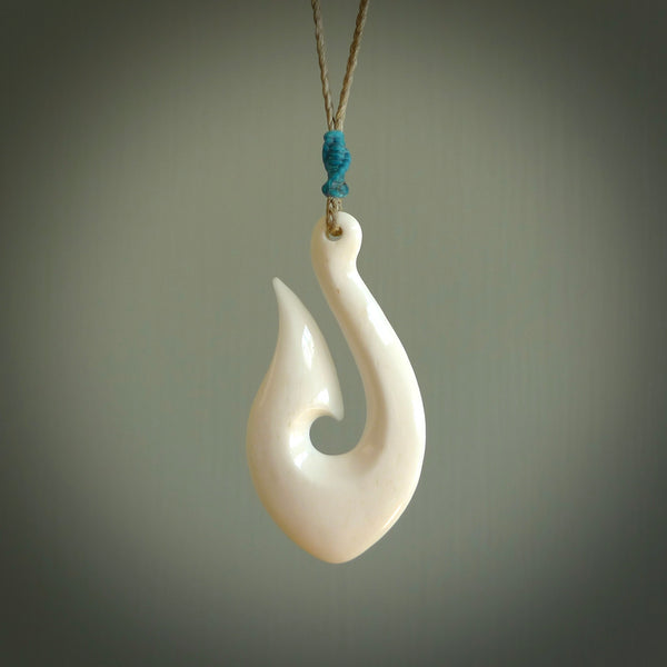 A fish hook necklace (hei-matau) hand-carved in a traditional style from Bone. These are glorious pieces!