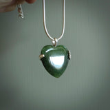 Hand crafted New Zealand jade heart in sterling silver hand necklace. This piece has a sterling silver hand holding a Jade heart. This necklace is provided with a sterling silver chain.