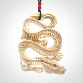 Hand carved incredible dragon Bone carving. A stunning work of art, beautifully replicating a dragon skeleton. This pendant was hand carved in bone and is a one off collectors item that has been hand crafted to be worn or displayed.