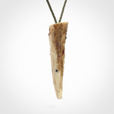 A hand carved crocodile pendant carved from a piece of deer antler. This is a work of art carved by Fumio Noguchi who is renowned for his skill in bone carving.