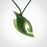 This photo shows a koru pendant carved from New Zealand Jade. We provide this piece with an adjustable green cord.
