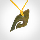 This photo shows a contemporary koru pendant carved into New Zealand Flower Jade. We have added a yellow adjustable cord. This is a fantastic work of art, we have one only.