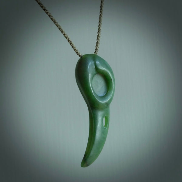Hand carved huia bird skull made from New Zealand Marsden Jade pendant. Carved for NZ Pacific by Kyohei Noguchi. This is a contemporary piece of jewellery that is carved with intricate detail and clearly shows a beautiful bird skull. We ship this free worldwide with Express Courier.
