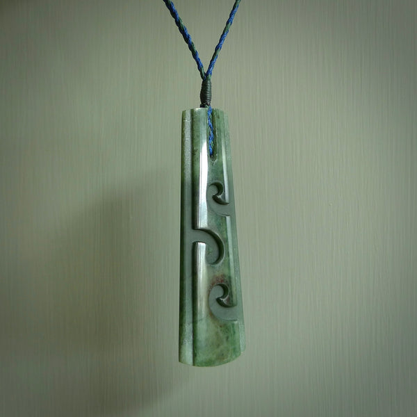 Hand made New Zealand jade drop with koru pendant. Hand carved in New Zealand by Kerry Thompson. Hand made jewellery. Unique large Jade drop with fixed length tan coloured cord. Free shipping worldwide.