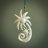 This is a hand carved palm tree pendant. It is made from bone. This is a large sized necklace and is a very unique. Hand carved bone palm tree necklace. Delivered on an adjustable cord.